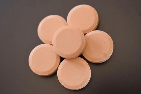 Calcium tablets on dark background Stock Photos