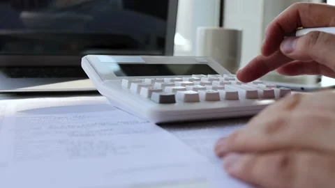 Calculate accounts and register data information with a calculator Stock Footage 202113663