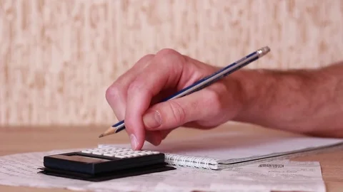 Calculating. Bills and glasses on table Stock Footage 83533492