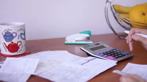 Calculating Bills On The Kitchen Table With Nervous Then Resigned Gesture Vídeo Stock 50602555