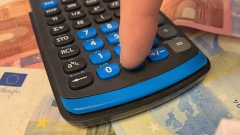Calculating with the calculator money in the background 2 Stock Footage 108151183
