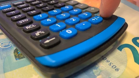 Calculating with the calculator money in the background Stock Footage 108150814
