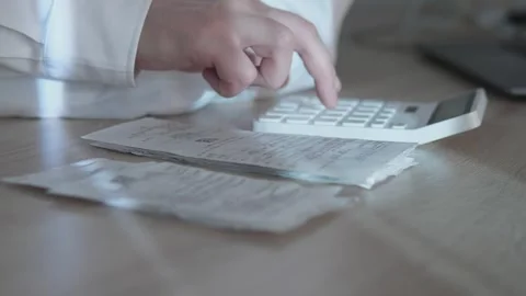 Calculating Expenses Effectively Using Receipts and a Calculator to Ensure Stock Footage 306180291