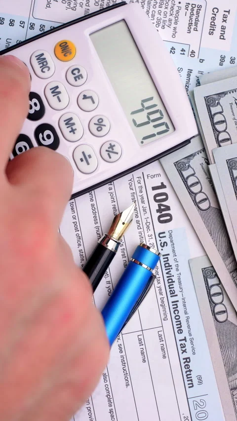 Calculating Income Tax Return.  Stock Footage 339199655