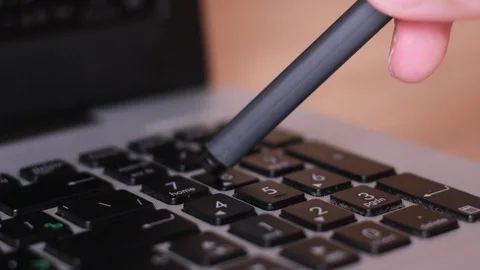 Calculating on notebook keyboard with pen Video stock 88763900