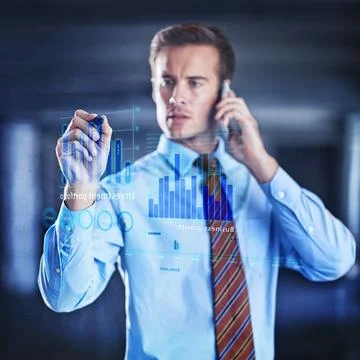 Calculating risks in a digital age. a handsome young businessman using a digital Stock Photos