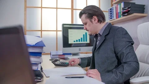 Calculating something on a calculator Stock Footage