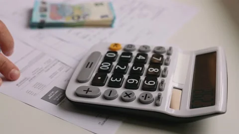 Calculating utility bills budget Stock Footage 198006333