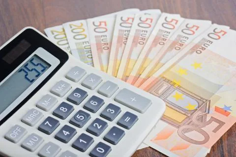 Calculator and banknotes on the table 스톡 사진