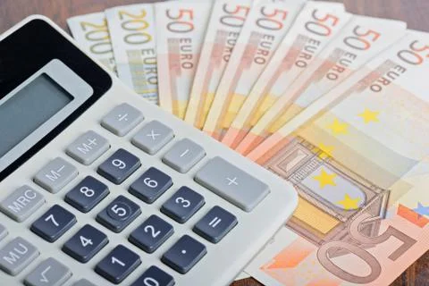 Calculator and banknotes on the table Stock Photos