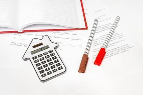 Calculator and contract on table Stock Photos