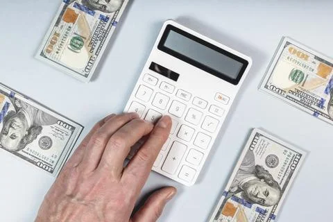 Calculator and dollars stack. Personal finance concept. Cash flow Foto stock