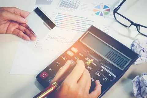 Calculator and Financial data analyzing using calculator and counting in of.. Stock Photos