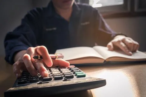 Calculator and Financial data analyzing using calculator and counting in of.. Stock Photos