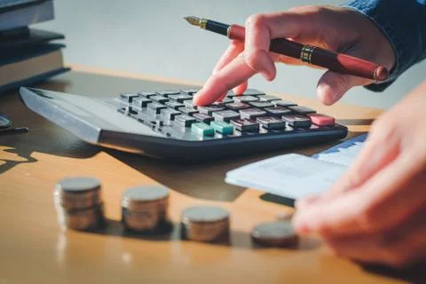 Calculator and Financial data analyzing hand writing and counting in office.. Foto stock