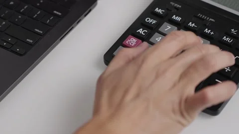 Calculator and laptop on a desk for efficient work and study sessions Stock Footage 321147864