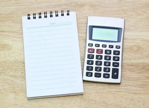 Calculator and notebook on table Stock Photos