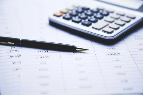 Calculator and pen  on document on table Stock Photos