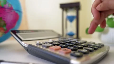 Calculator and Time Management Tools in Office Setting Stock Footage 318056804