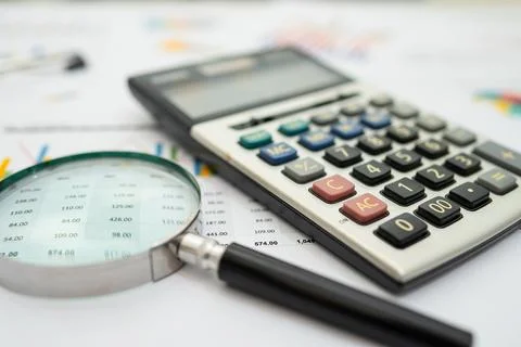Calculator on chart and graph spreadsheet paper. Finance development, Banki.. Stock Photos