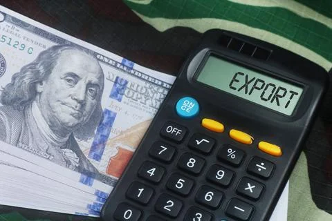 Calculator displaying export alongside a stack of US dollar bills, symboliz.. Stock Photos