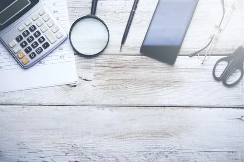 Calculator with document and phone on table Stock Photos