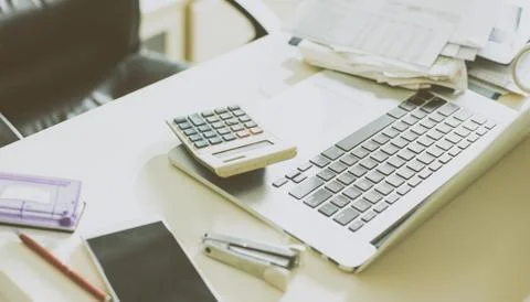 Calculator, documents and laptop on the table of business person Stock Photos