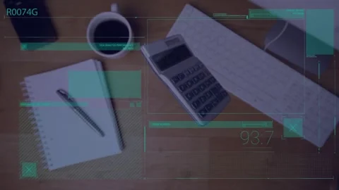 A calculator falls onto an office desk next to a computer and a notepad Stock Footage 329362405