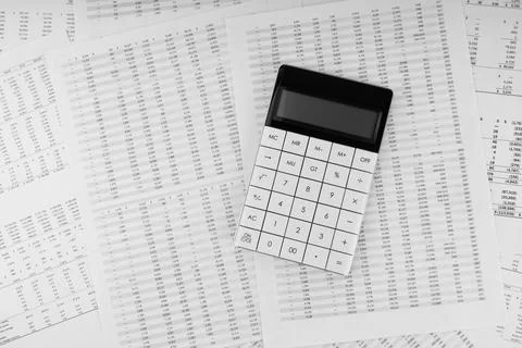 Calculator on financial statement. Financial and business concept. Top view. Stock Photos