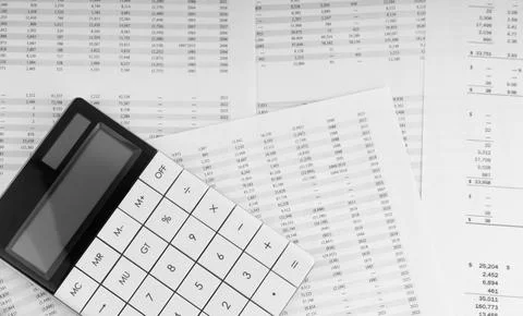 Calculator on financial statement. Stock Photos