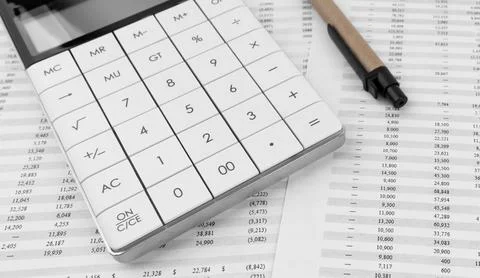 Calculator on financial statement. Stock Photos