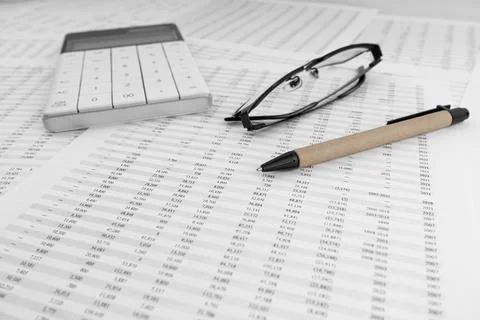 Calculator on financial statement. Top view. Stock Photos