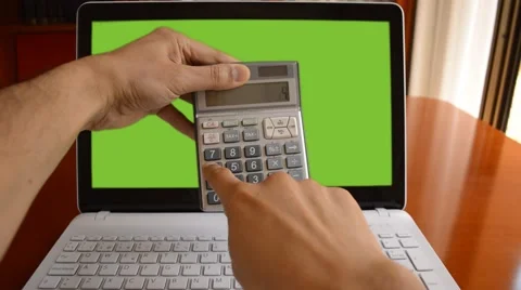 Calculator in front of a laptop Vidéo 49317645