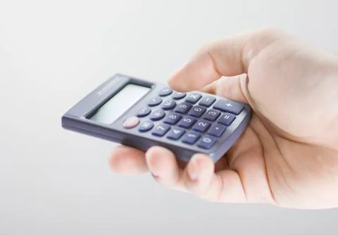 Calculator in hand Stock Photos