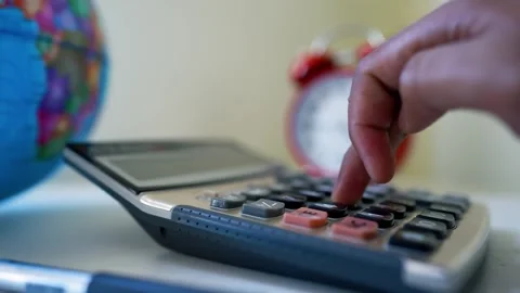 Calculator with hand pressing button and globe Stock Footage 317737102