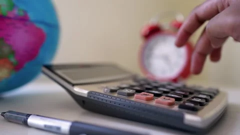 Calculator with hand pressing button and globe Stock Footage 317737106