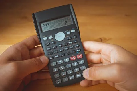 Calculator in hands with the calculation 1+1=2 Stock Photos