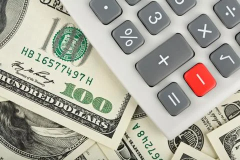 Calculator with minus red button over dollars Stock Photos