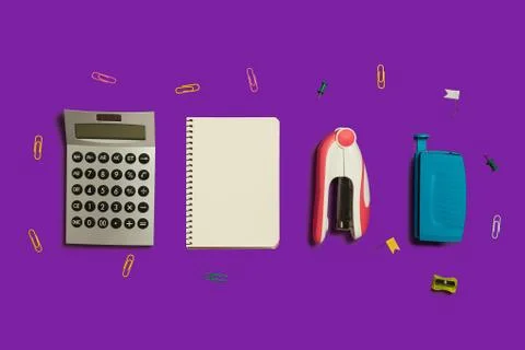 Calculator, notebook and stapler Stock Photos