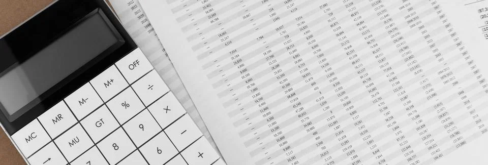 Calculator with notebook on financial statement. Stock Photos