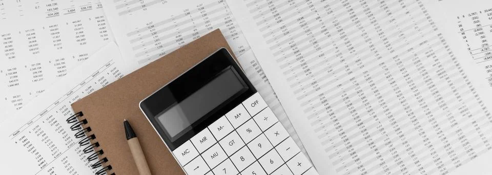 Calculator with notebook on financial statement. Stock Photos