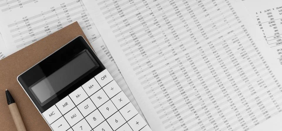 Calculator with notebook on financial statement. Stock Photos