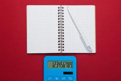 Calculator with notebook on red background. Education process. Top view. Flat Stockfoto's