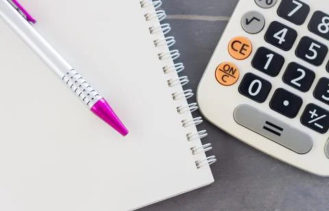 Calculator, notepad and pen on grey background Stock Photos