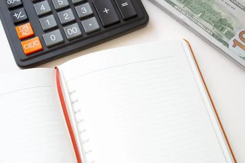 Calculator notepad and stack of money on white background 写真素材