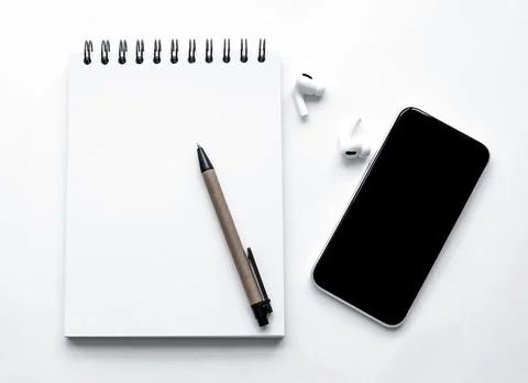Calculator, notepad, spiral notebook, pen, AirPods, headphones, on white Stock-Fotos
