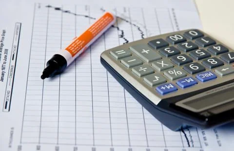 Calculator on paper  graph . Stock-Fotos