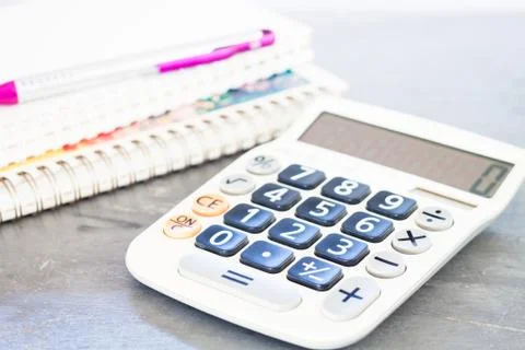 Calculator, pen and notepad for notes Stock Photos