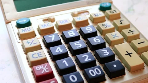 A calculator sitting on a table, with a flat surface and possibly used for work Stock Footage 322536071