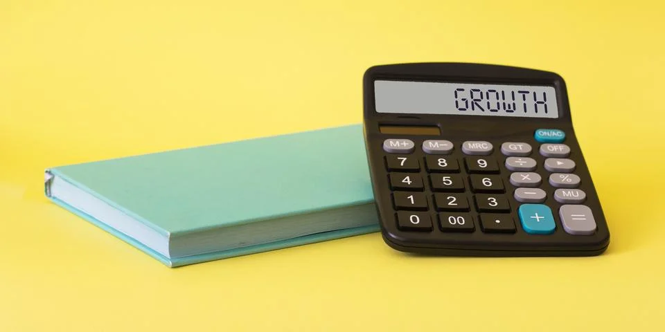 Calculator on a solid yellow background with a turquoise notebook, The calcul Stock Photos